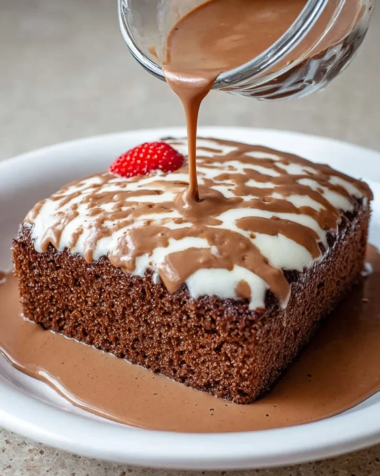 Slice of Easy Chocolate Tres Leches Cake topped with chocolate drizzle and whipped cream