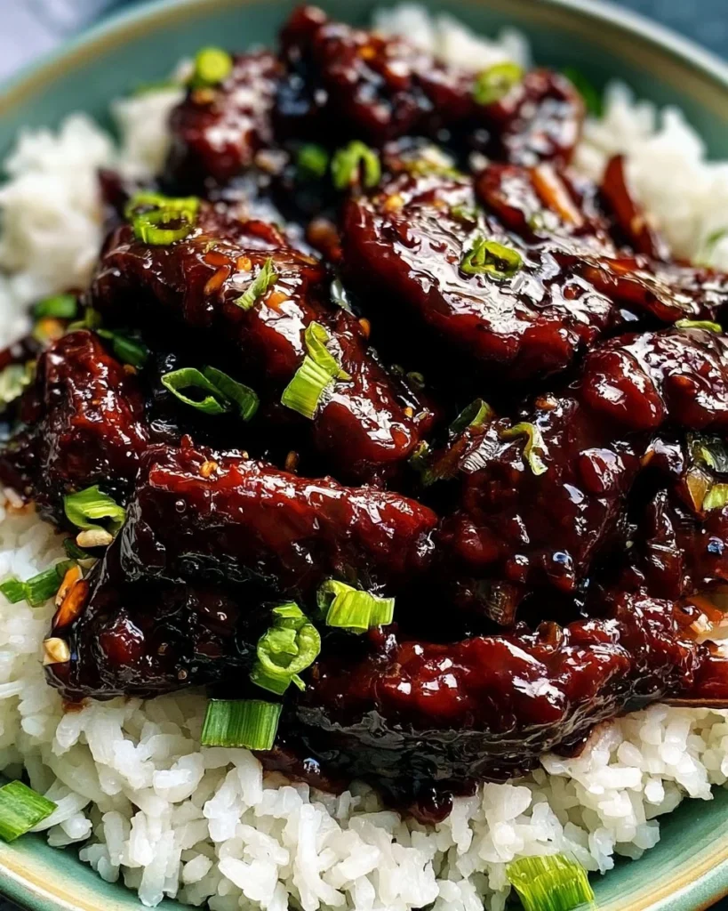 PF Chang's Mongolian Beef served on a plate with rice and vegetables