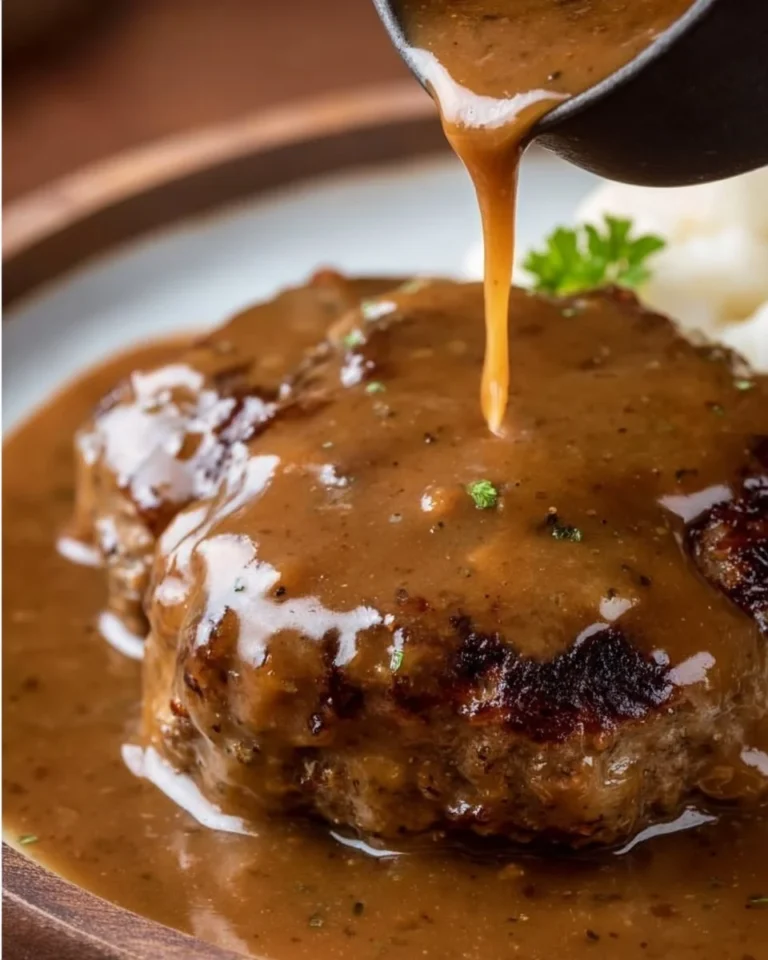 Quick hamburger steak served with rich brown gravy on a plate.