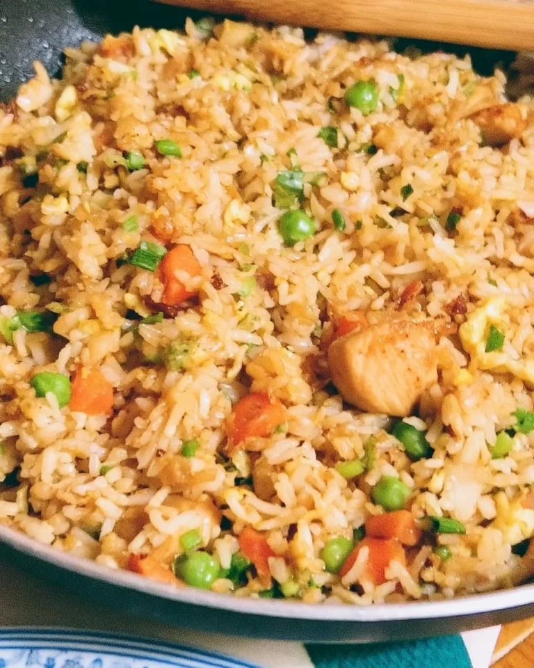 A bowl of chicken fried rice with vegetables and chicken pieces for an easy weeknight meal