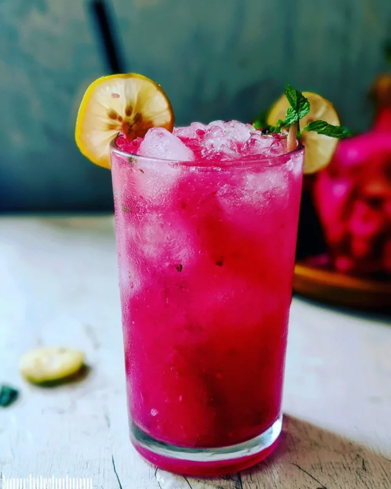 Homemade mango dragonfruit refresher in a glass with fresh fruits