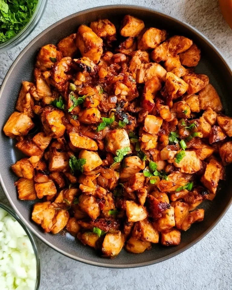 Plate of high protein chipotle chicken with fresh ingredients and spices